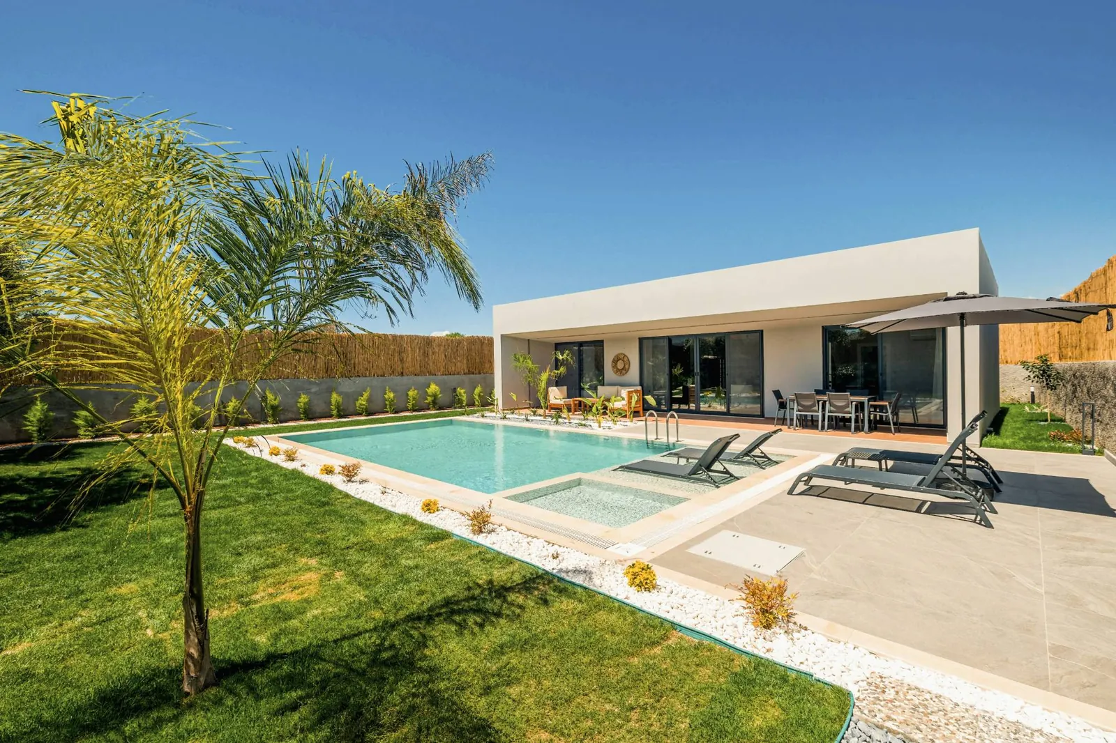 A contemporary villa with pool and garden