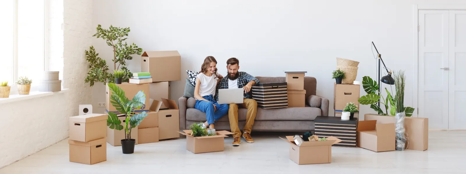 A couple in their living room surrounded by moving boxes